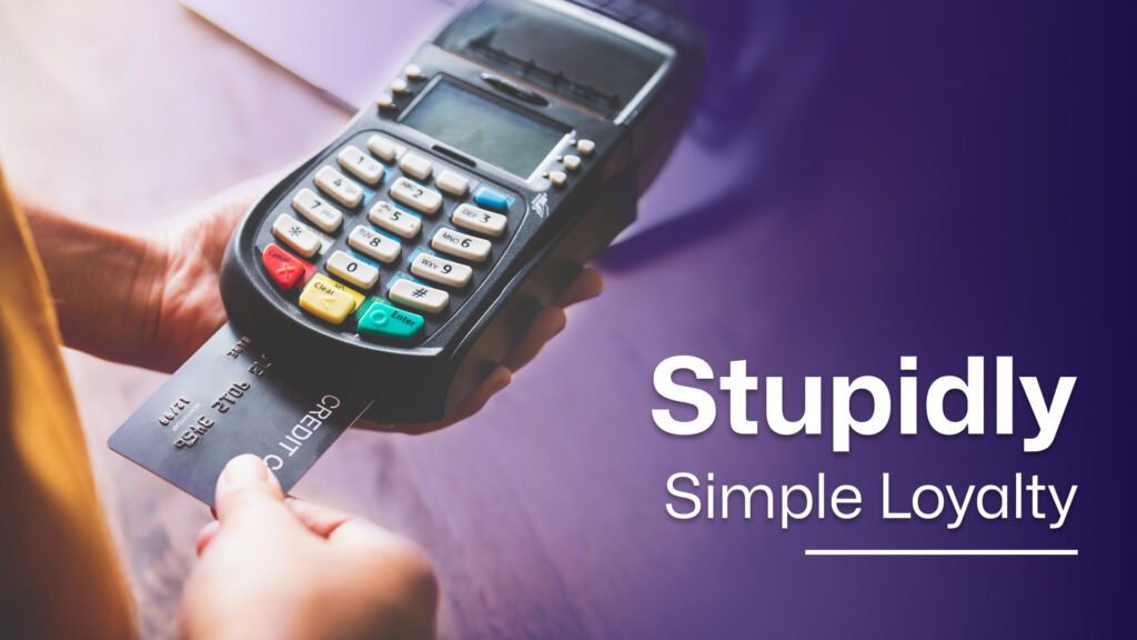 A person inserting a credit card into a payment terminal with the text ‘Stupidly Simple Loyalty’ on a purple overlay.